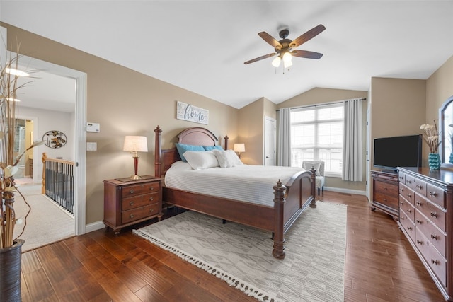 2545 Silver Oak Trl, Marion, IA 52302 - bedroom with dark wood-style flooring, vaulted ceiling, baseboards, and a ceiling fan