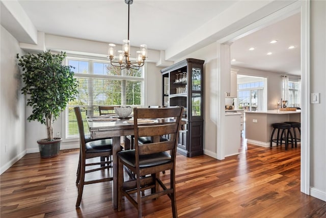 2545 Silver Oak Trl, Marion, IA 52302 - dining area with plenty of natural light, dark wood-type flooring, a chandelier, recessed lighting, and baseboards