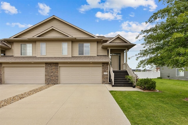 1330 Redbud Ave, Tiffin, IA 52340 - view of property featuring an attached garage, driveway, and stone siding