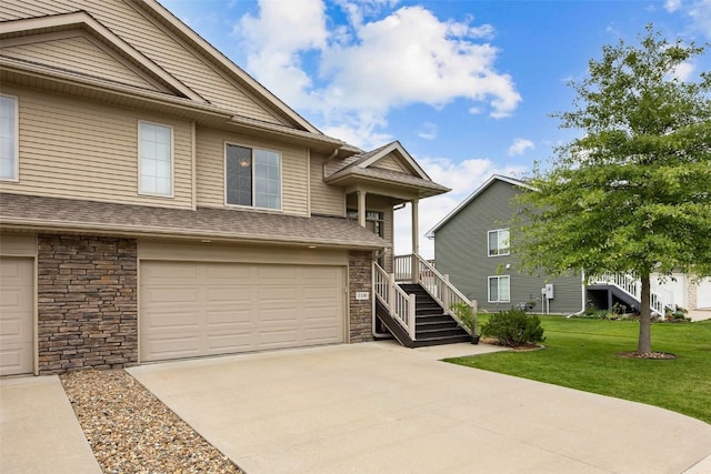 1330 Redbud Ave, Tiffin, IA 52340 - view of front facade with stone siding, a front yard, an attached garage, and concrete driveway