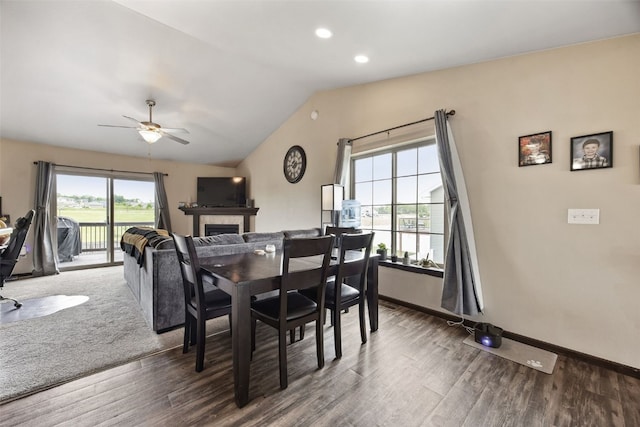 1330 Redbud Ave, Tiffin, IA 52340 - dining room featuring wood finished floors, lofted ceiling, a tile fireplace, ceiling fan, and baseboards