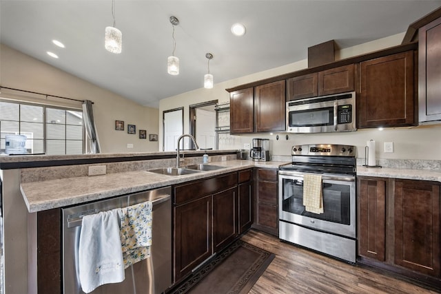 1330 Redbud Ave, Tiffin, IA 52340 - kitchen featuring stainless steel appliances, a sink, a peninsula, dark brown cabinets, and lofted ceiling
