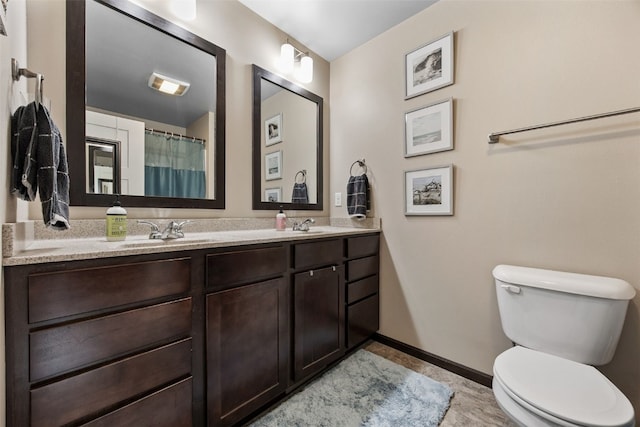 1330 Redbud Ave, Tiffin, IA 52340 - full bathroom featuring double vanity, baseboards, and toilet