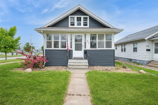 662 19th Ave SW, Cedar Rapids, IA 52404 - view of front facade with entry steps, a front yard, and a sunroom
