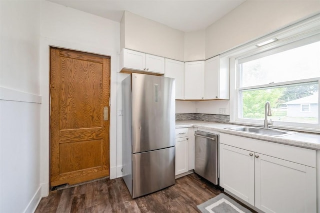 662 19th Ave SW, Cedar Rapids, IA 52404 - kitchen featuring a sink, appliances with stainless steel finishes, dark wood-style floors, and white cabinets