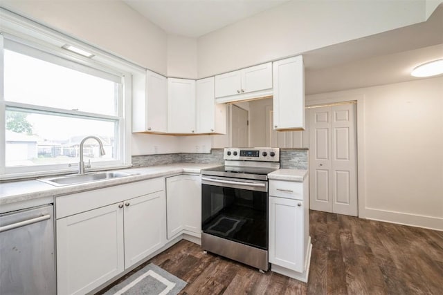 662 19th Ave SW, Cedar Rapids, IA 52404 - kitchen with appliances with stainless steel finishes, a sink, dark wood-type flooring, and light countertops
