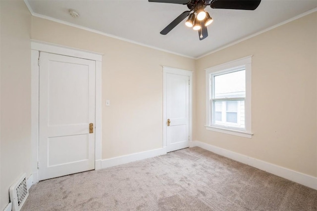 662 19th Ave SW, Cedar Rapids, IA 52404 - unfurnished bedroom featuring carpet floors, ornamental molding, baseboards, and a ceiling fan