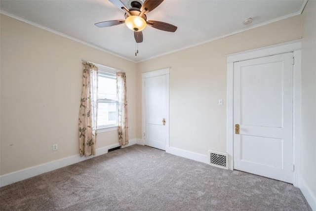 662 19th Ave SW, Cedar Rapids, IA 52404 - unfurnished bedroom with carpet flooring, crown molding, baseboards, and ceiling fan