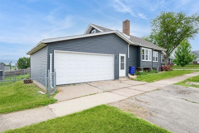662 19th Ave SW, Cedar Rapids, IA 52404 - ranch-style house with driveway, a chimney, an attached garage, and cooling unit