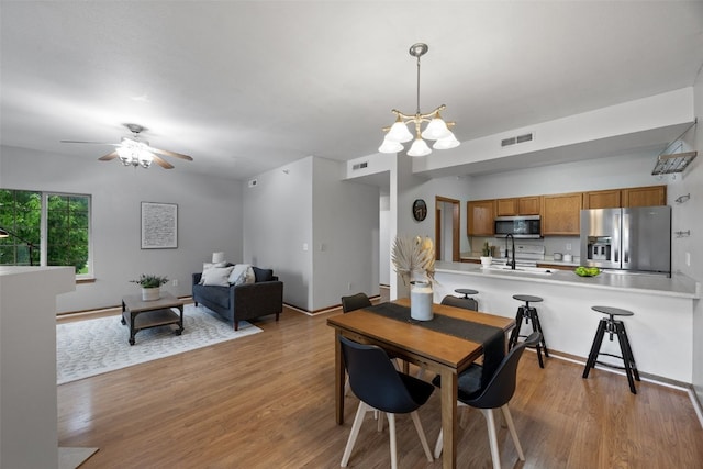 364 Camden Rd, Iowa City, IA 52245 - dining area with wood finished floors, ceiling fan, and a chandelier