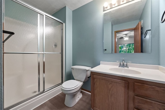 364 Camden Rd, Iowa City, IA 52245 - bathroom featuring vanity, toilet, a stall shower, wood finished floors, and ceiling fan