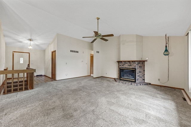 1042 Arthur Dr NW, Cedar Rapids, IA 52405 - unfurnished living room with carpet flooring, a ceiling fan, a fireplace, and high vaulted ceiling