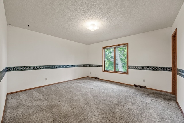 1042 Arthur Dr NW, Cedar Rapids, IA 52405 - carpeted spare room with baseboards and a textured ceiling