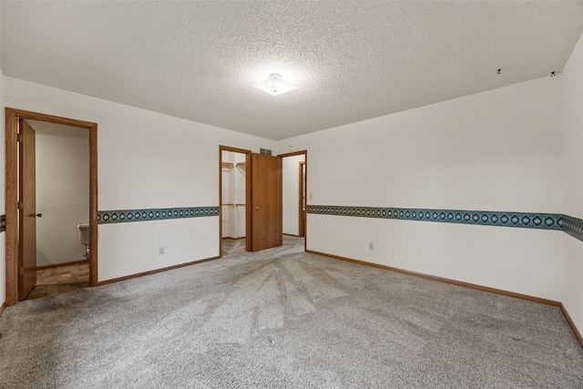 1042 Arthur Dr NW, Cedar Rapids, IA 52405 - carpeted spare room with baseboards and a textured ceiling