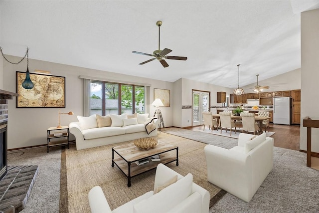 1042 Arthur Dr NW, Cedar Rapids, IA 52405 - living room with ceiling fan, vaulted ceiling, and a fireplace