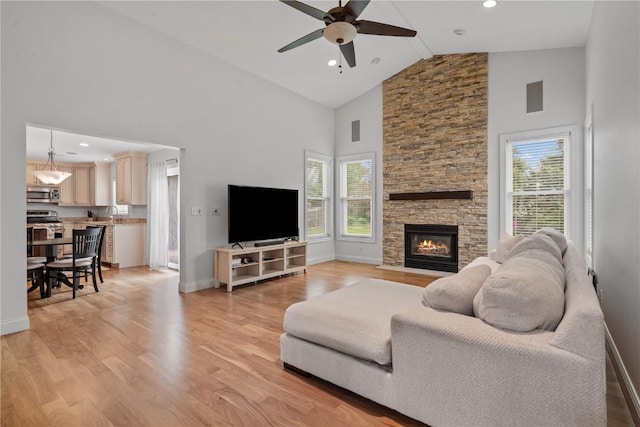 4000 Majestic Ct NE, Cedar Rapids, IA 52411 - living area featuring high vaulted ceiling, ceiling fan, healthy amount of natural light, light wood finished floors, and baseboards