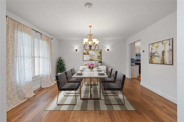 4000 Majestic Ct NE, Cedar Rapids, IA 52411 - dining area with baseboards, a chandelier, and wood finished floors