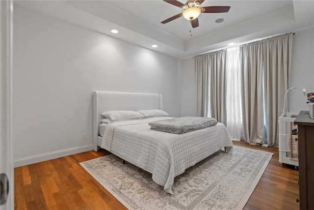 4000 Majestic Ct NE, Cedar Rapids, IA 52411 - bedroom featuring ornamental molding, a tray ceiling, recessed lighting, wood finished floors, and baseboards