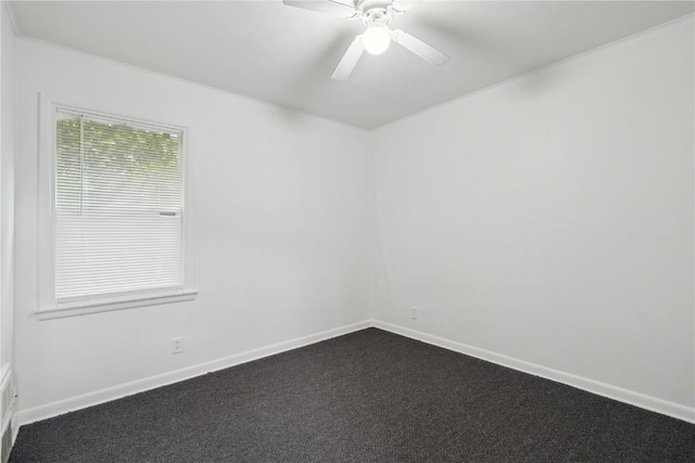 654 34th St SE, Cedar Rapids, IA 52403 - spare room featuring dark carpet, baseboards, a ceiling fan, and crown molding
