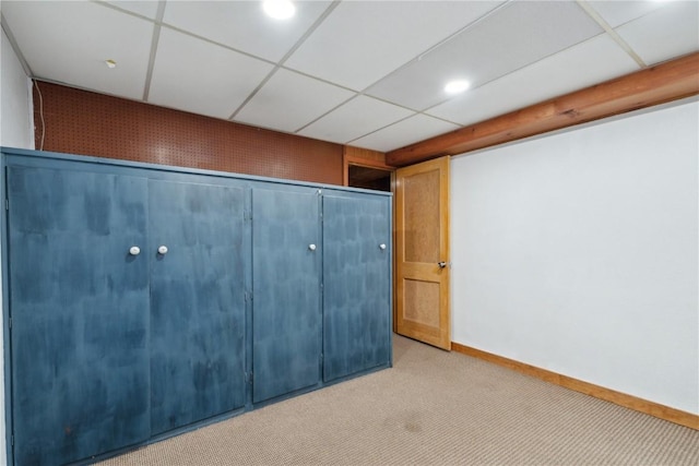 654 34th St SE, Cedar Rapids, IA 52403 - finished below grade area with light colored carpet, a drop ceiling, and baseboards