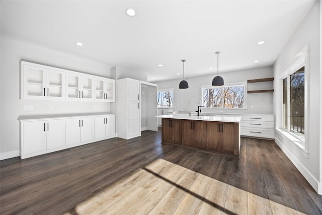 1504 Legend Dr, Tiffin, IA 52340 - kitchen featuring white cabinetry, a sink, light countertops, recessed lighting, and a kitchen island with sink