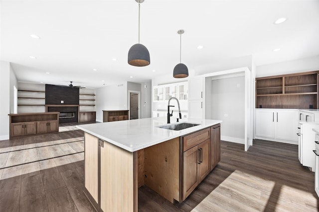 1504 Legend Dr, Tiffin, IA 52340 - kitchen featuring a sink, dark wood-style floors, recessed lighting, an island with sink, and light countertops