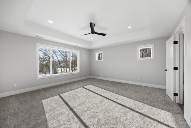 1504 Legend Dr, Tiffin, IA 52340 - unfurnished bedroom with a raised ceiling, carpet, recessed lighting, baseboards, and ceiling fan