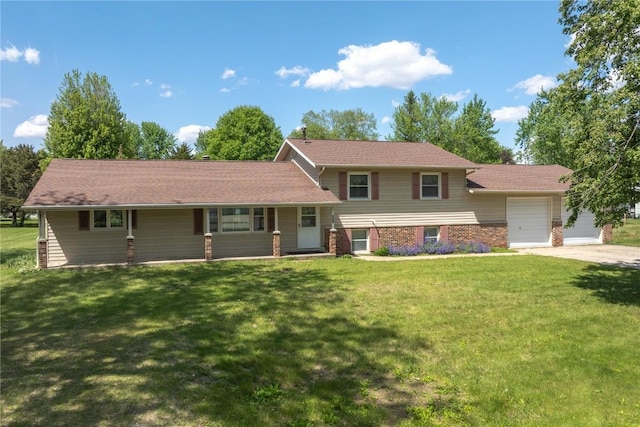 409 Oak St, Rowley, IA 52329 - tri-level home with a garage, a front yard, a porch, and brick siding