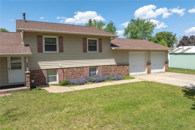 409 Oak St, Rowley, IA 52329 - split level home featuring brick siding, a front yard, and driveway
