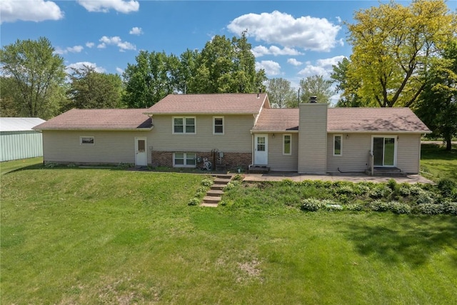 409 Oak St, Rowley, IA 52329 - back of house featuring a lawn, a chimney, and a patio area