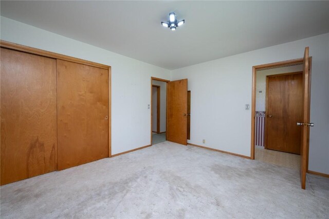 409 Oak St, Rowley, IA 52329 - unfurnished bedroom with carpet flooring, a closet, and baseboards