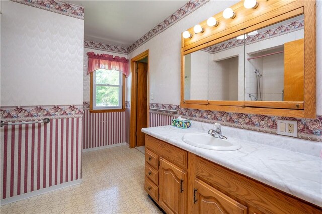 409 Oak St, Rowley, IA 52329 - bathroom with vanity, tile patterned floors, wainscoting, and wallpapered walls
