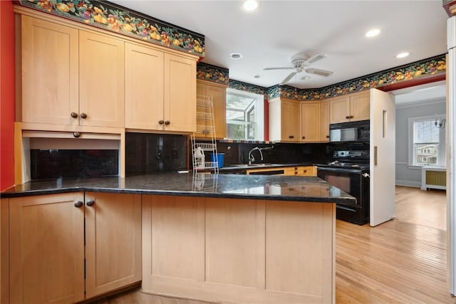 2325 Grande Ave SE, Cedar Rapids, IA 52403 - kitchen featuring black appliances, healthy amount of natural light, a peninsula, backsplash, and recessed lighting