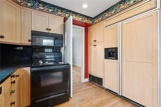 2325 Grande Ave SE, Cedar Rapids, IA 52403 - kitchen featuring black appliances, dark countertops, light wood-style floors, light brown cabinetry, and recessed lighting