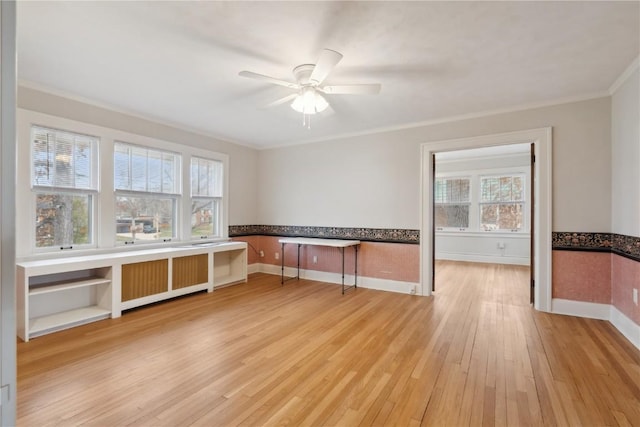 2325 Grande Ave SE, Cedar Rapids, IA 52403 - empty room with ornamental molding, light wood-style flooring, plenty of natural light, a ceiling fan, and baseboards