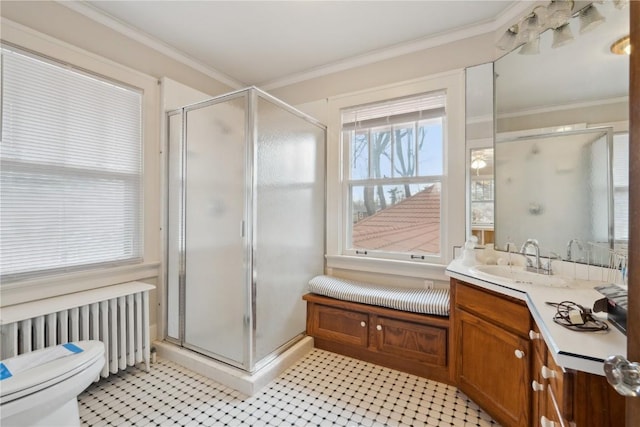 2325 Grande Ave SE, Cedar Rapids, IA 52403 - bathroom with radiator heating unit, vanity, toilet, a stall shower, and ornamental molding