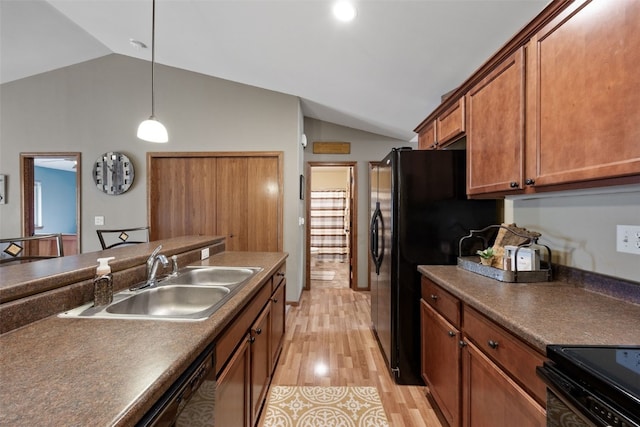 302 Duchess Dr, Solon, IA 52333 - kitchen with vaulted ceiling, a sink, dark countertops, light wood-style floors, and brown cabinets