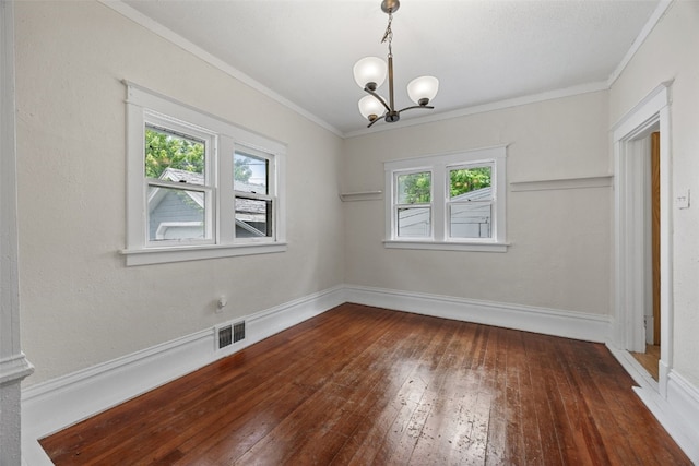 414 18th St, Cedar Rapids, IA 52403 - unfurnished dining area with hardwood / wood-style floors, healthy amount of natural light, a chandelier, crown molding, and baseboards