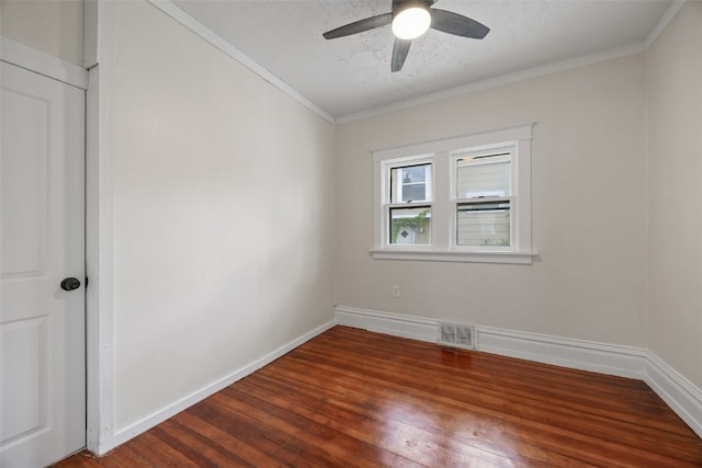 414 18th St, Cedar Rapids, IA 52403 - unfurnished room with crown molding, dark wood finished floors, a textured ceiling, ceiling fan, and baseboards