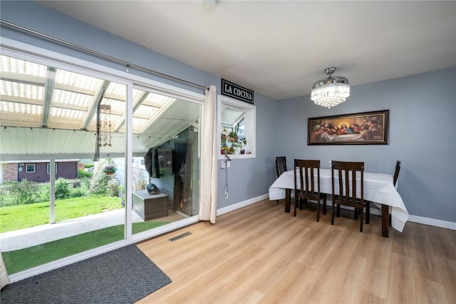 4721 Midway Dr NW, Cedar Rapids, IA 52405 - dining room featuring a chandelier, wood finished floors, and a skylight