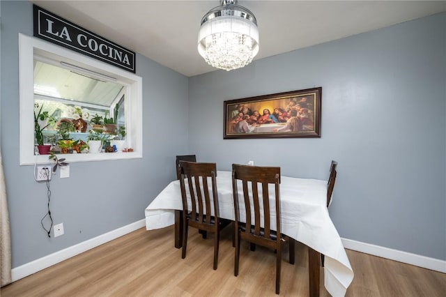 4721 Midway Dr NW, Cedar Rapids, IA 52405 - dining area featuring a chandelier and wood finished floors