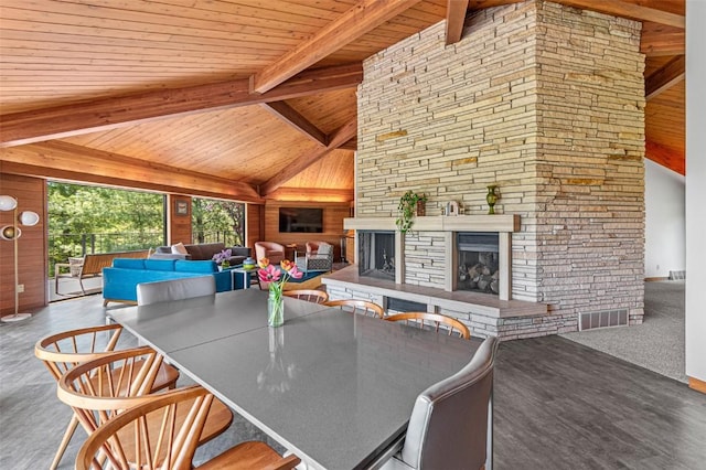 3715 170th St NE, Solon, IA 52333 - living room featuring wooden ceiling with exposed beams, a fireplace, wood walls, and high vaulted ceiling