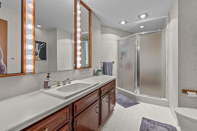 3715 170th St NE, Solon, IA 52333 - bathroom with vanity, a shower stall, toilet, tile patterned flooring, and wallpapered walls
