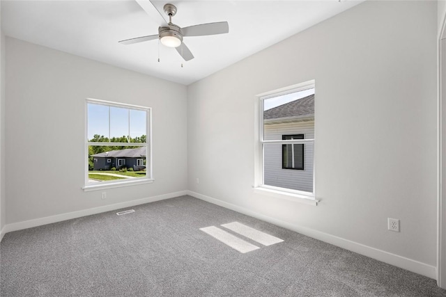 706 Silver Ln, Iowa City, IA 52245 - carpeted empty room with plenty of natural light, baseboards, and ceiling fan
