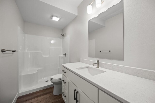 706 Silver Ln, Iowa City, IA 52245 - bathroom with toilet, vanity, a shower, and wood finished floors