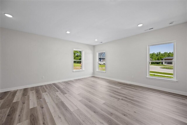 706 Silver Ln, Iowa City, IA 52245 - unfurnished room with healthy amount of natural light, light wood finished floors, recessed lighting, and baseboards