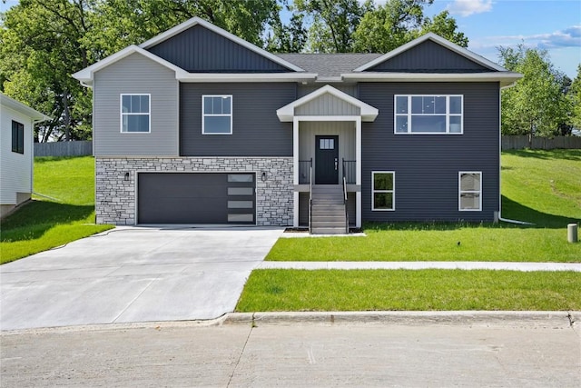 706 Silver Ln, Iowa City, IA 52245 - raised ranch featuring a garage, concrete driveway, and stone siding