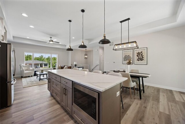 706 Silver Ln, Iowa City, IA 52245 - kitchen with appliances with stainless steel finishes, open floor plan, recessed lighting, ceiling fan, and light wood-style flooring