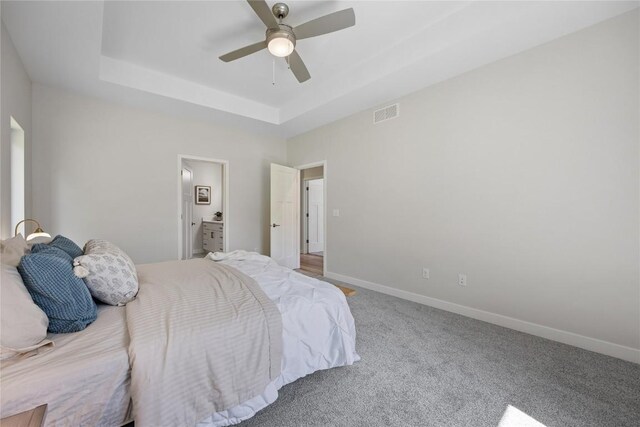 706 Silver Ln, Iowa City, IA 52245 - carpeted bedroom featuring a raised ceiling, baseboards, and a ceiling fan