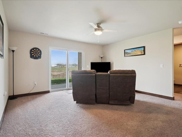 902 Creekside Dr, Tiffin, IA 52340 - living area featuring light colored carpet, a ceiling fan, and baseboards
